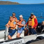 Joan Wilkins (middle, striped shirt) volunteered at Jutten Island, helping to protect nesting seabirds.