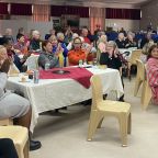 Tarentaal residents clap their hands to the music.